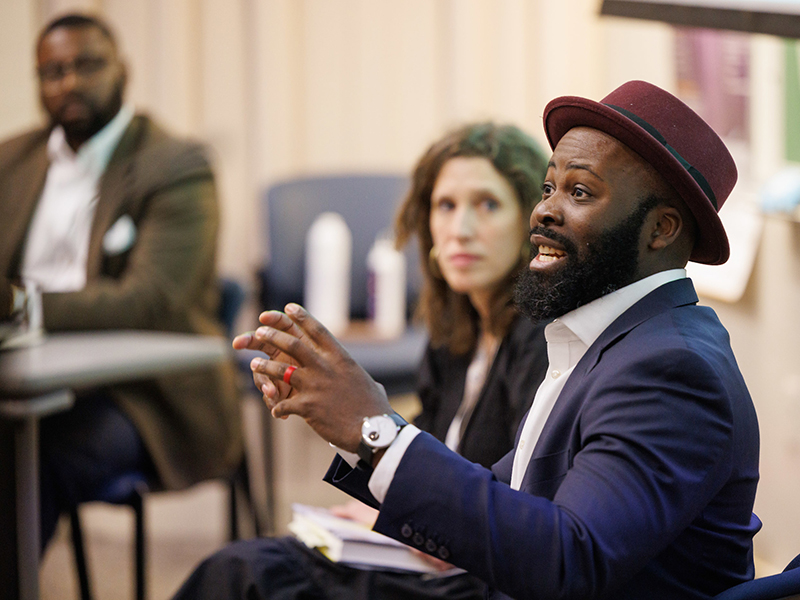 Dr. Joseph C. Ewoodzie speaks during a presentation on his book as Elizabeth Lutz, associate professor of Obstetrics and Gynecology in the School of Medicine